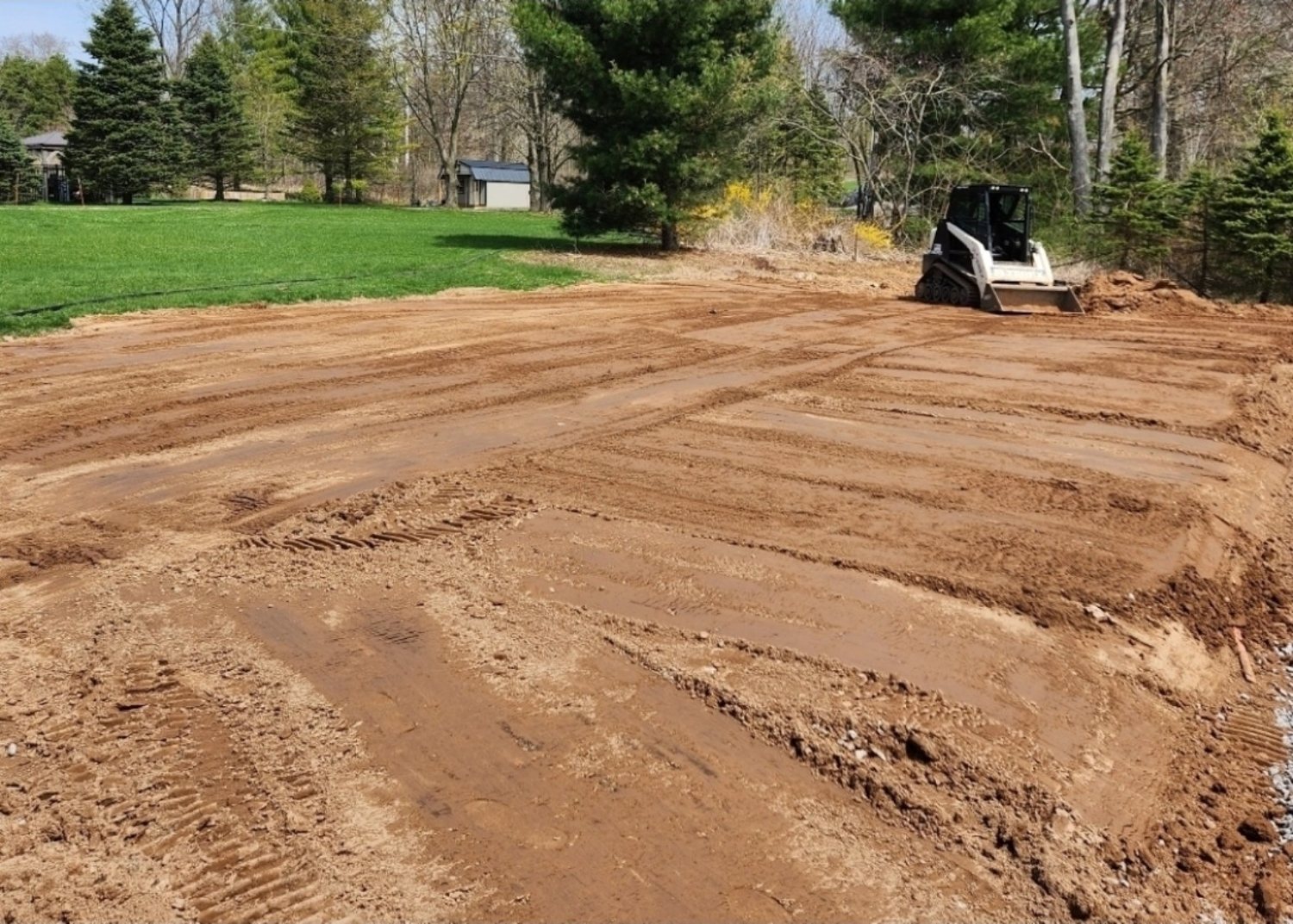 Residential ground grading with compact track loader